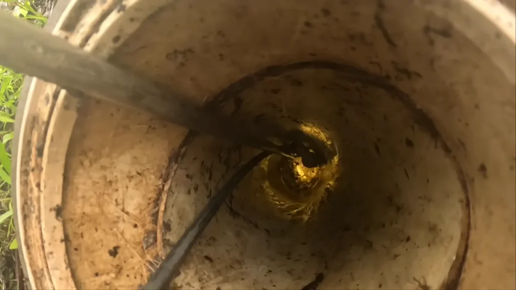Hydro jetting nozzle clearing a blocked pipe